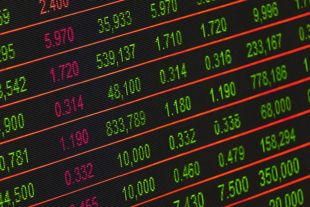 A financial data display board with rows of figures in green and red